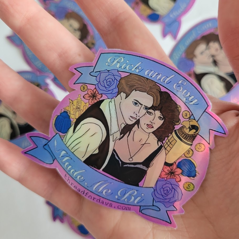 rick and evy made me bi sticker held in palm