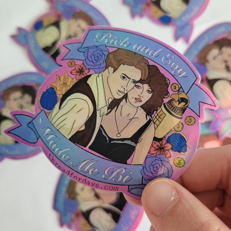 rick and evy made me bi sticker held in hand