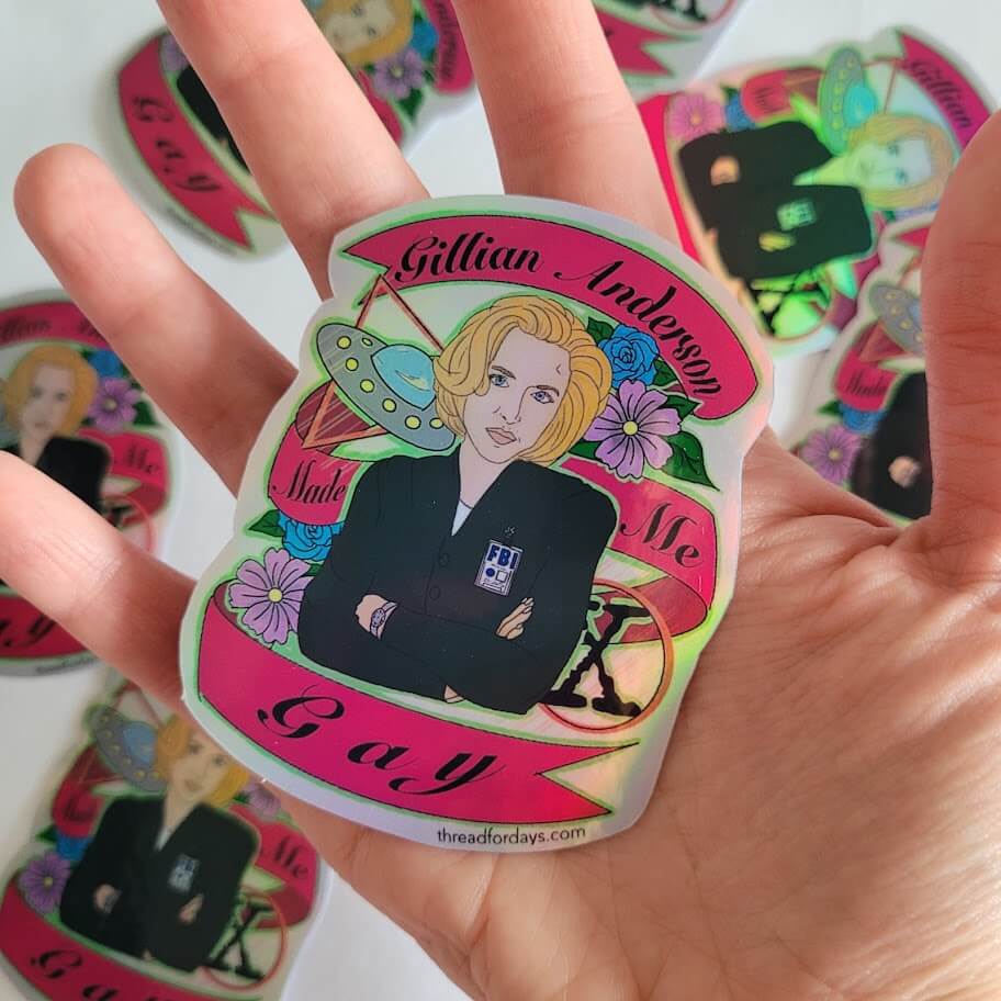 gillian anderson made me gay sticker held in palm
