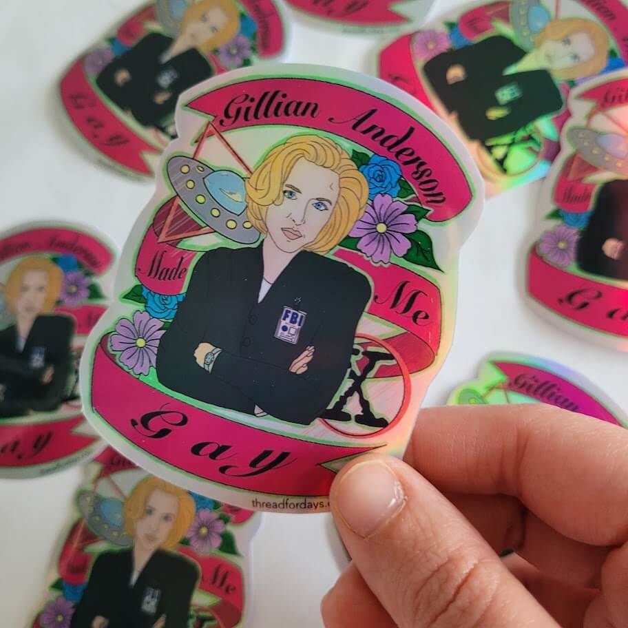 gillian anderson made me gay sticker held in hand