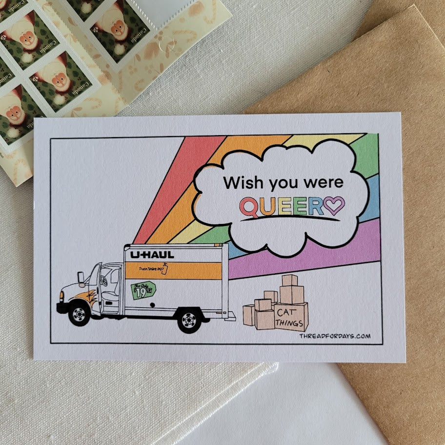 front of with you were queer postcard resting on a table