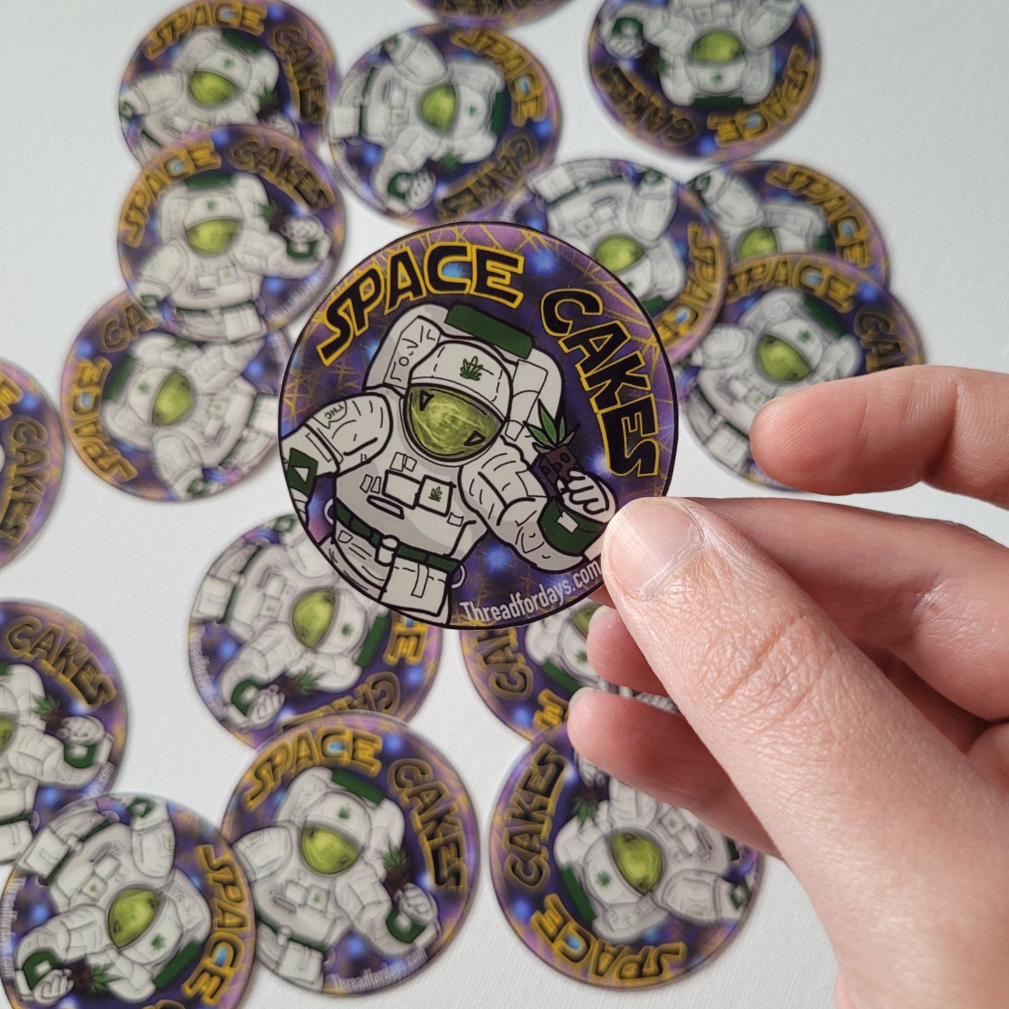 space cakes sticker held in hand