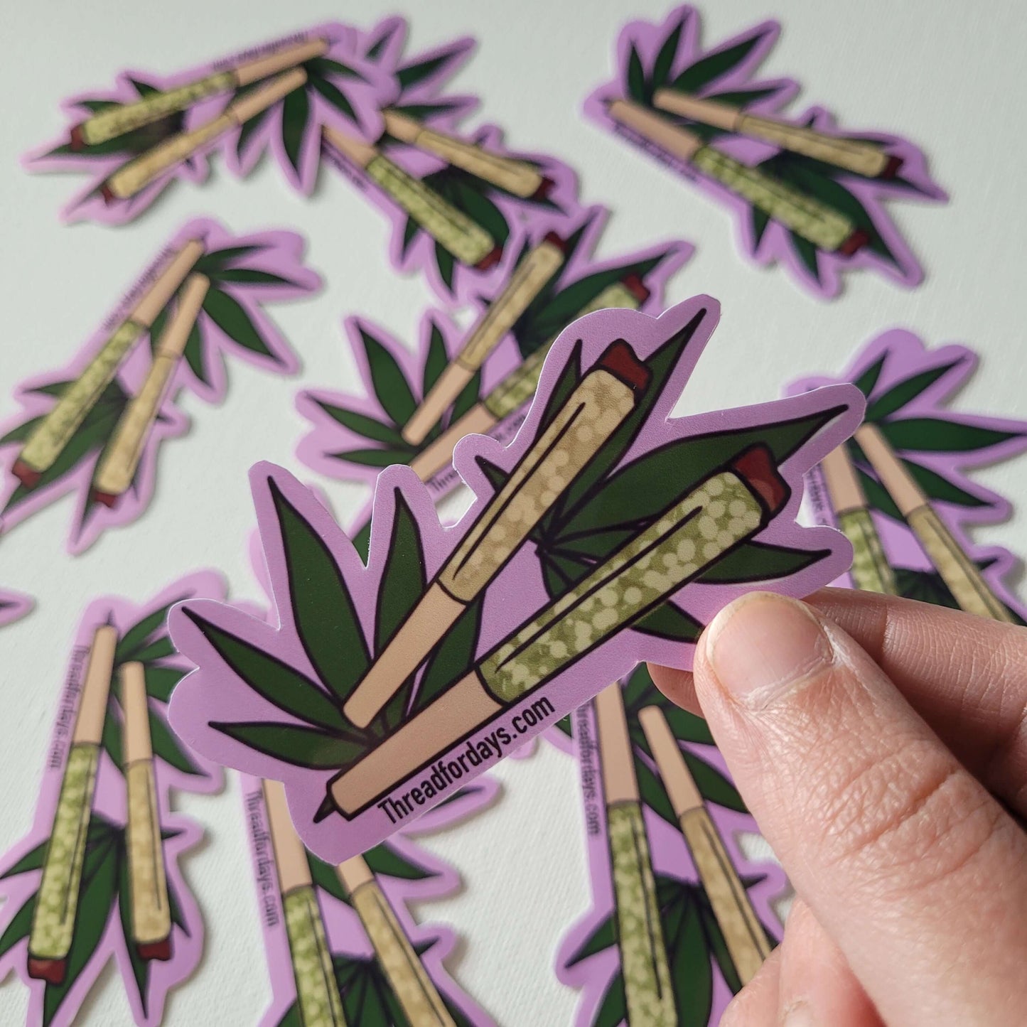 double joint sticker held in hand