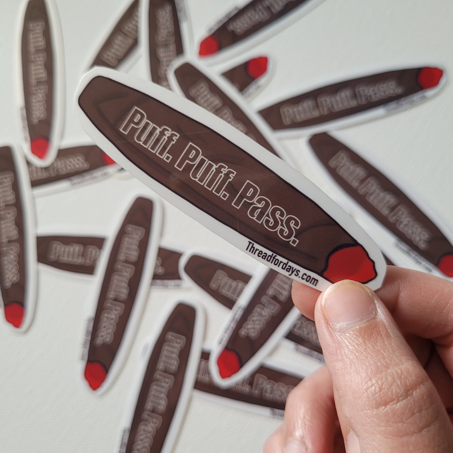 puff puff pass sticker held in hand