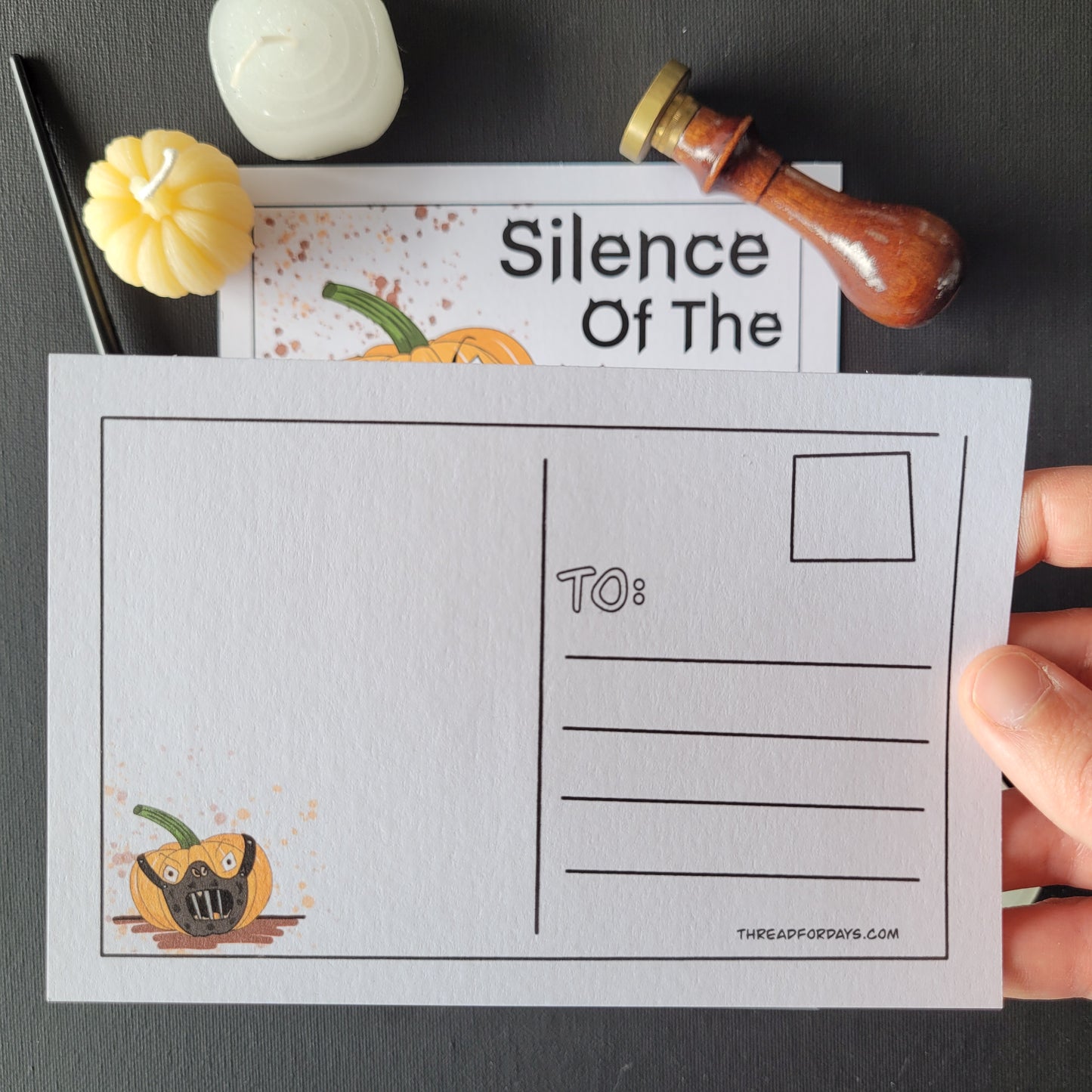 back of silence of the yams postcard featuring the large pumpkin from the front wearing the hannibal lector mask