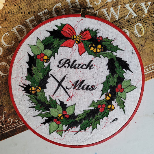 front of black christmas hoop.