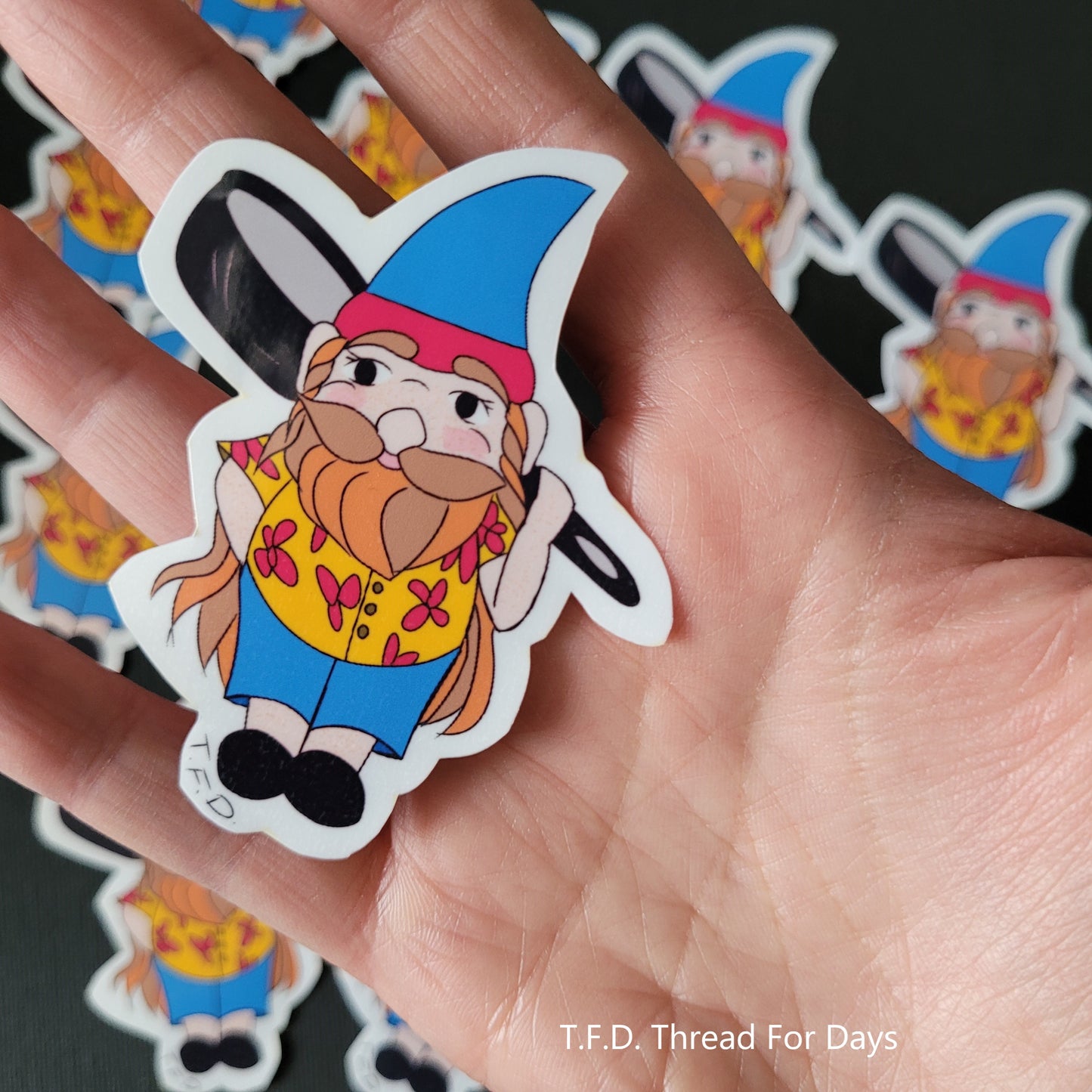 pansexual gnome sticker held in palm of hand for size reference