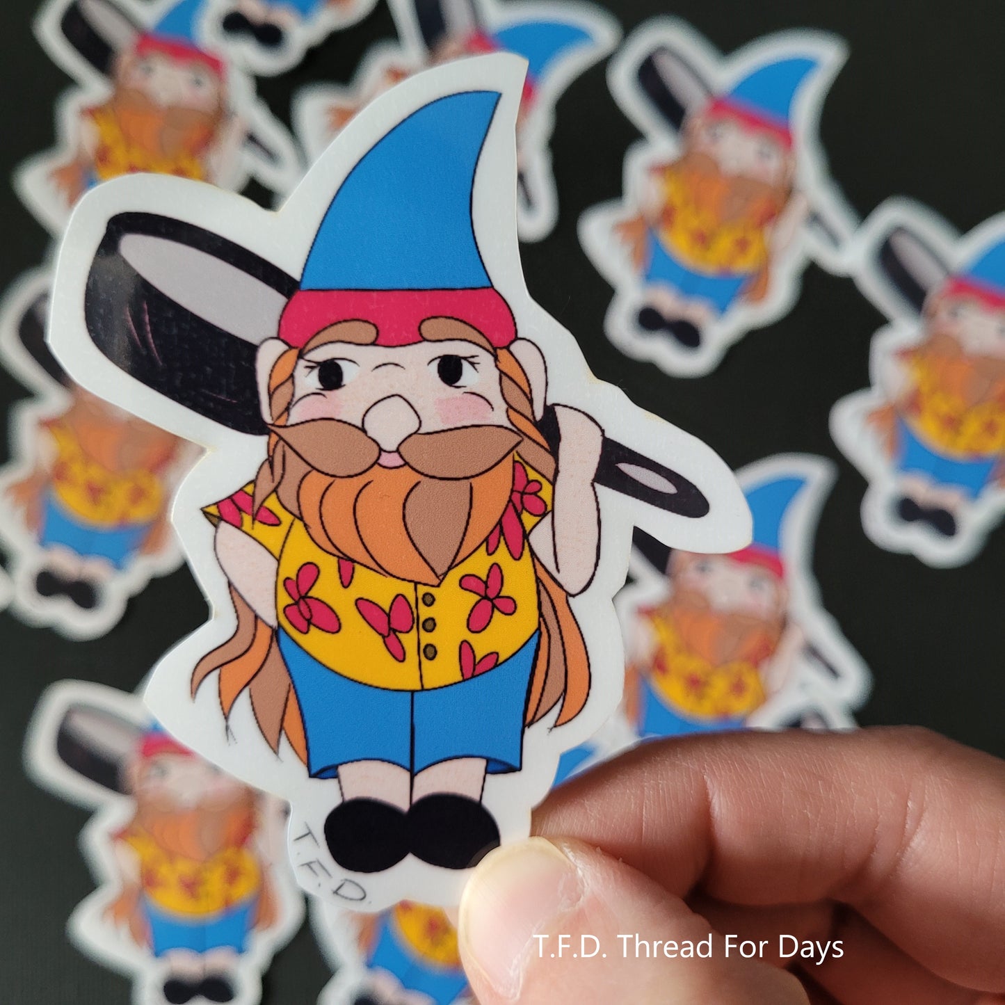 pansexual gnome sticker held between fingers