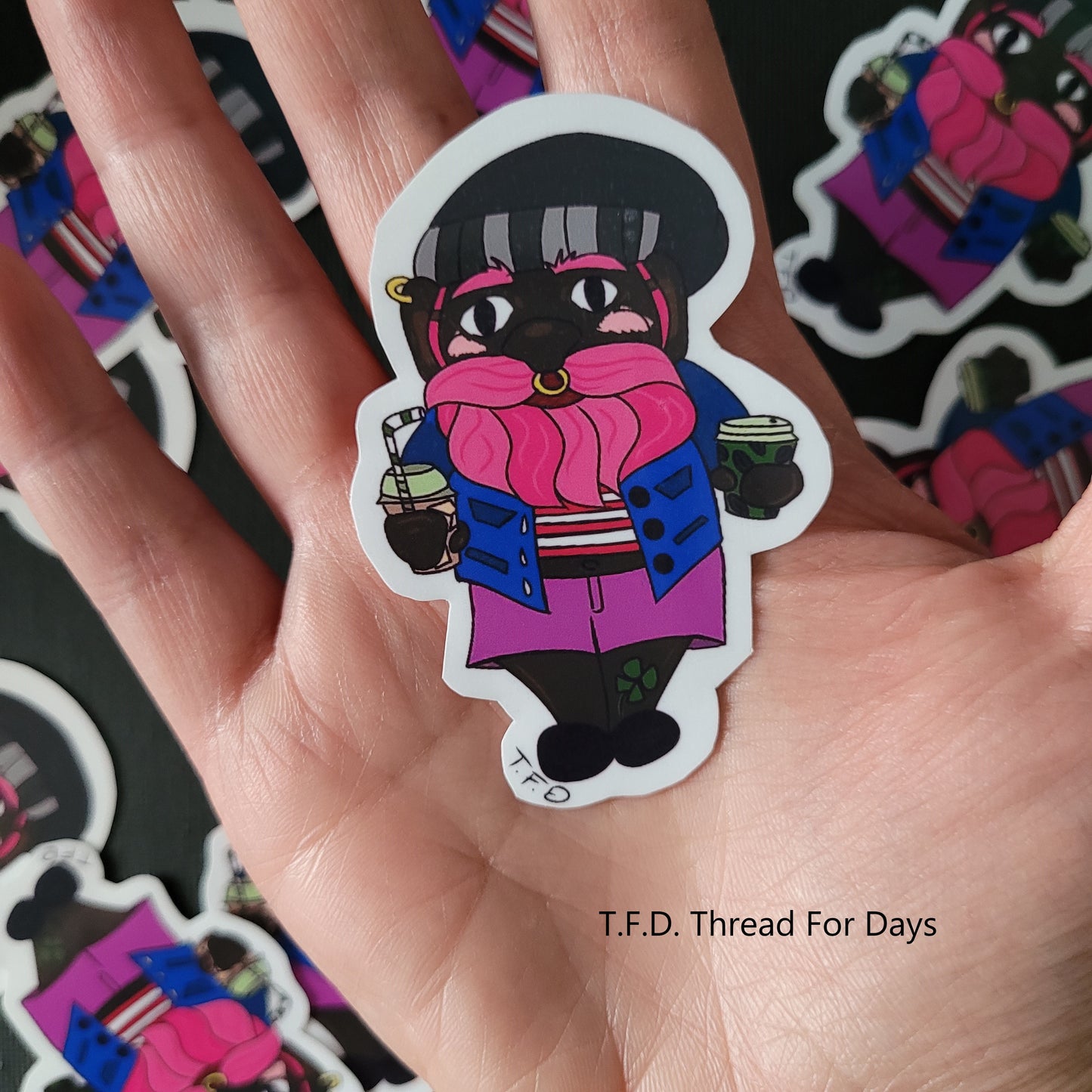 bisexual gnome sticker held in palm to indicate size