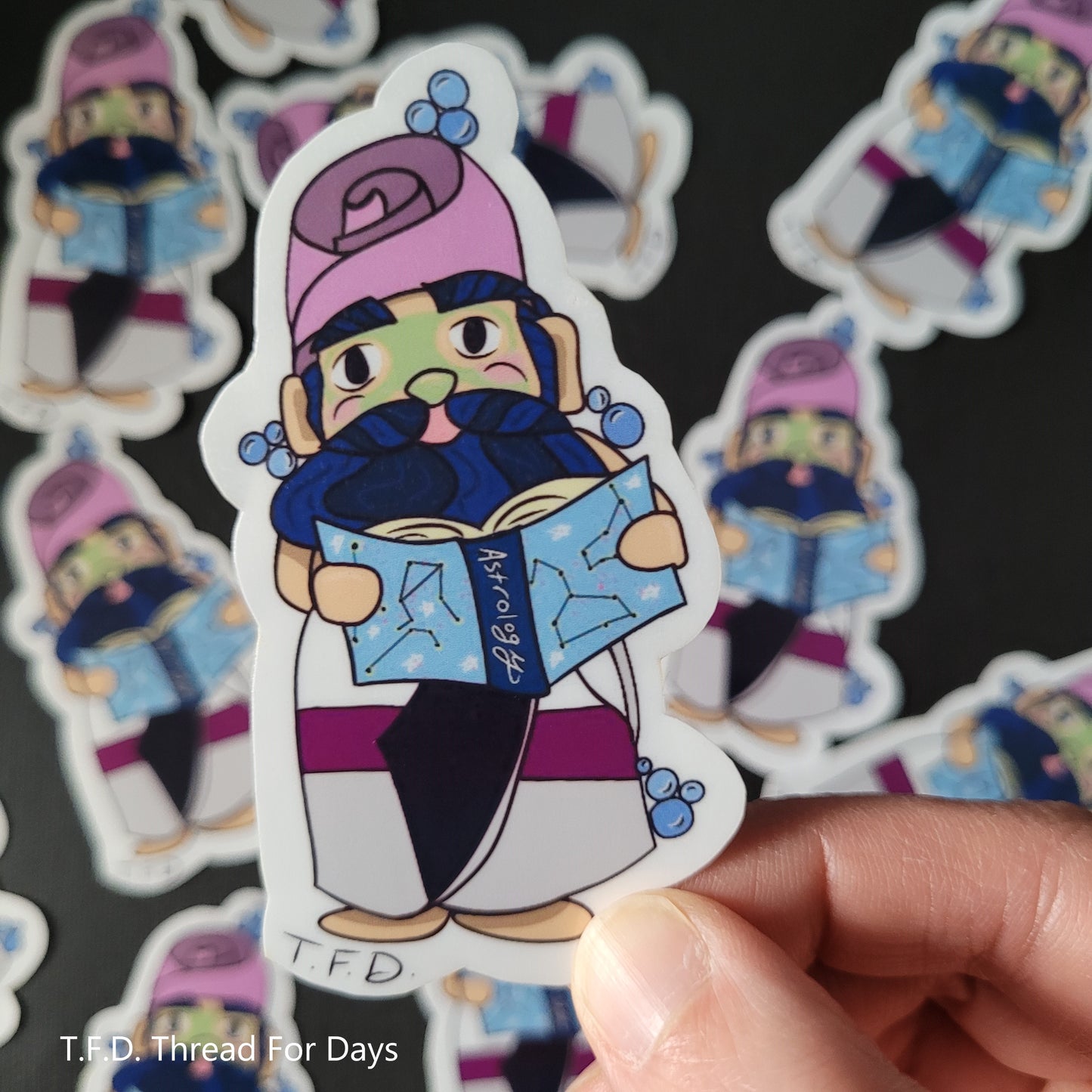 demisexual gnome sticker held between fingers