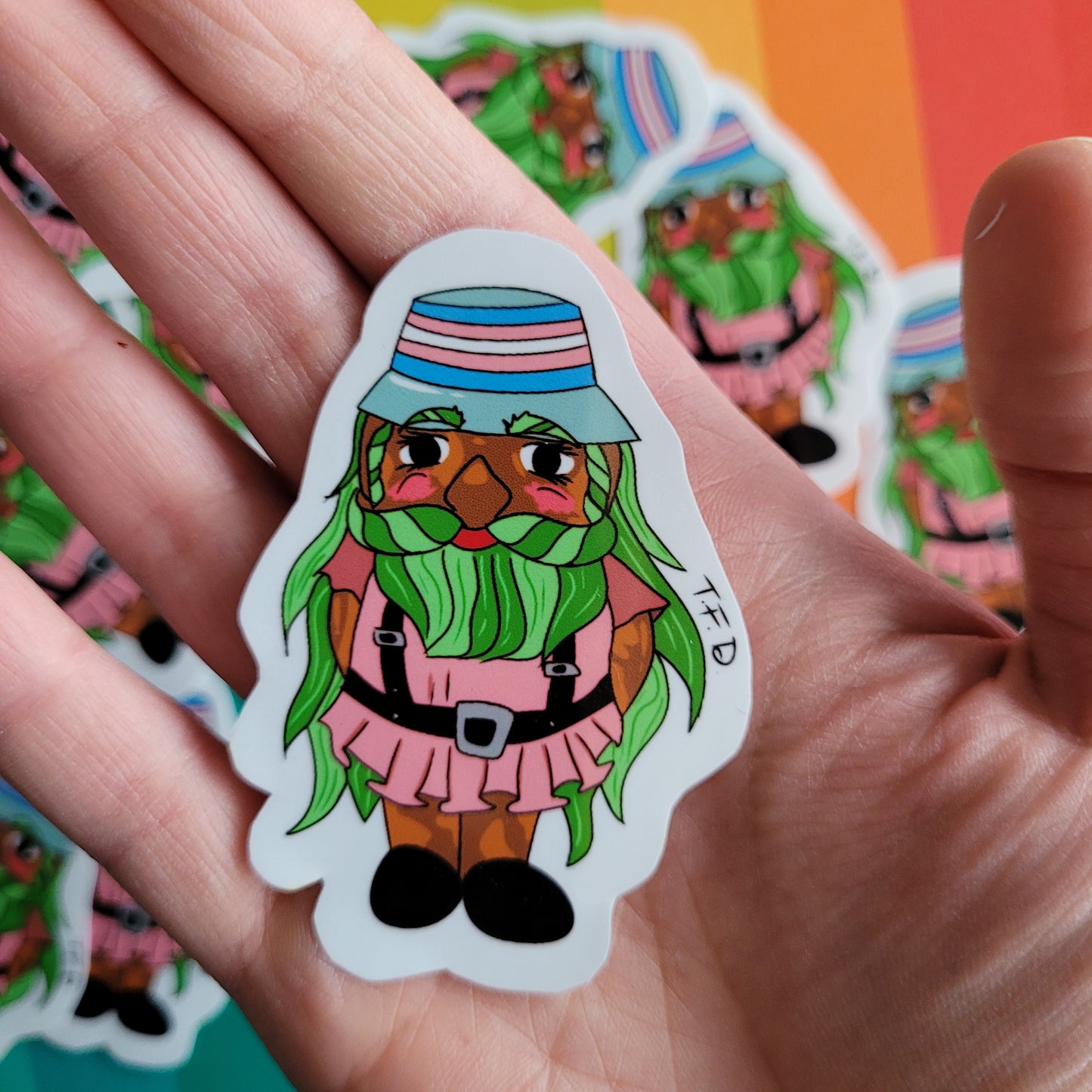 trans gnome held in palm of hand for size