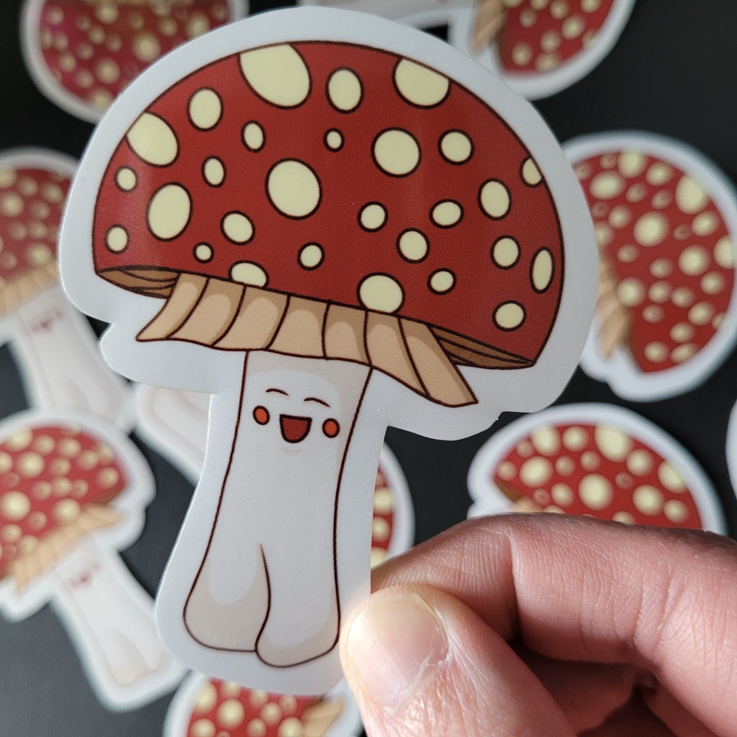 anamita muscaria sticker held between stickers