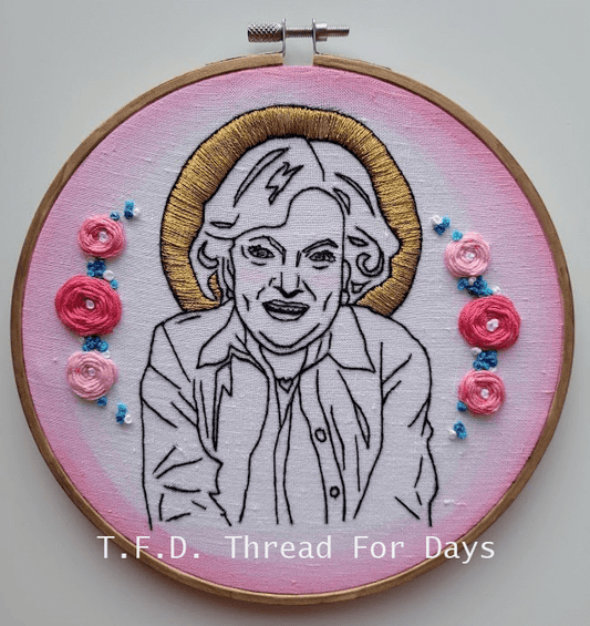 betty white surrounded by roses and a golden halo.