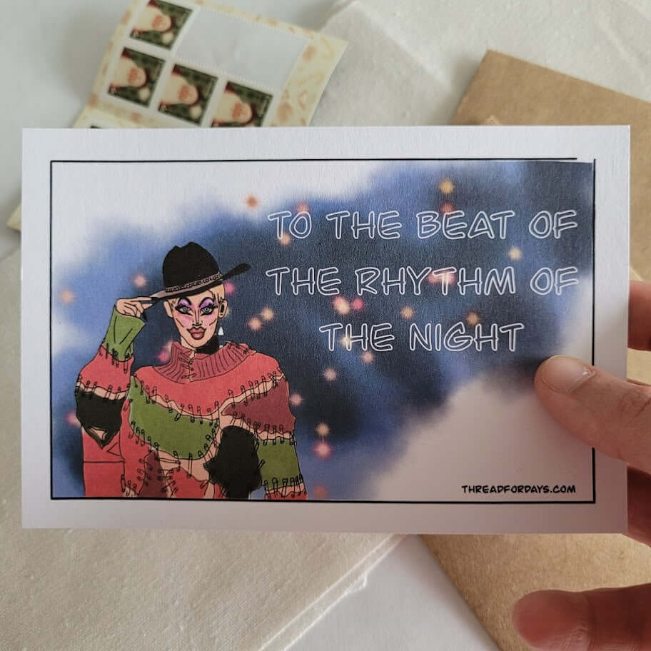 front of crystal methyd postcard held in hand