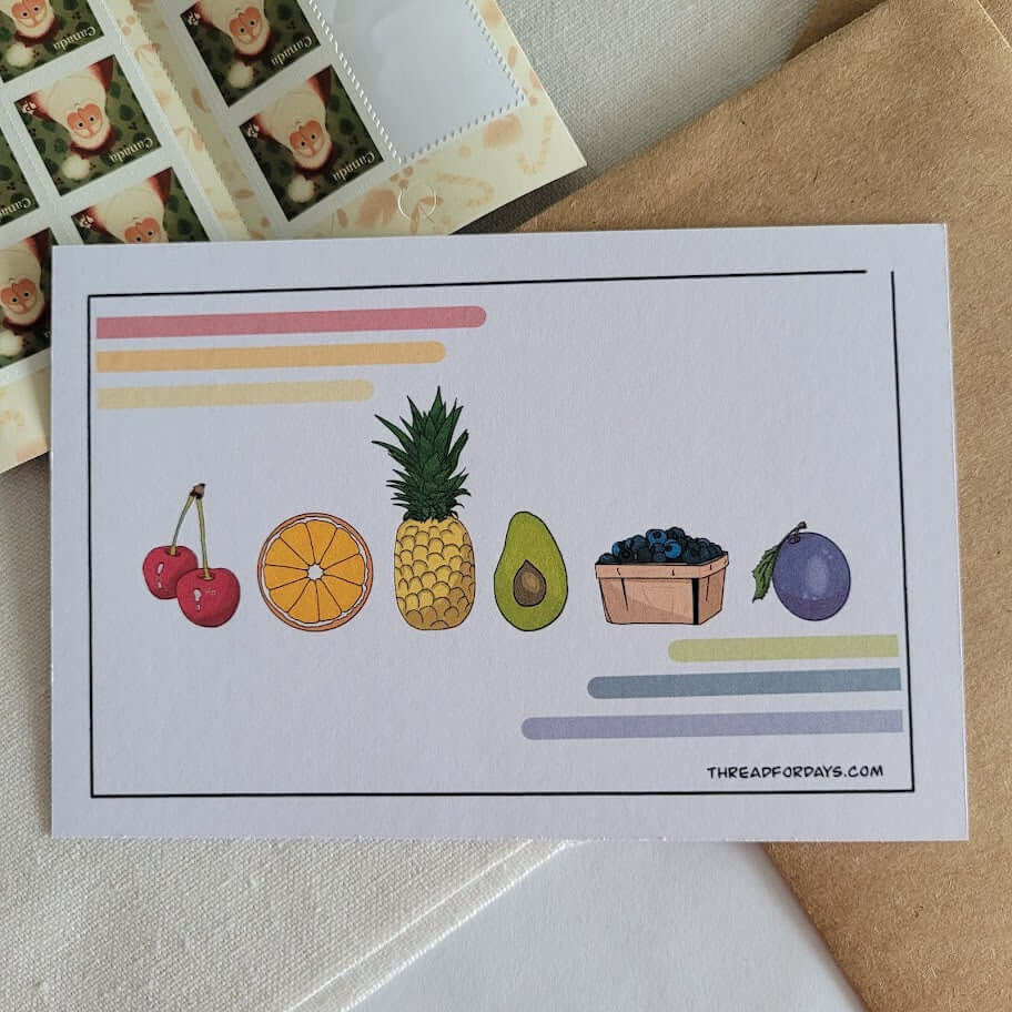 front of fruity postcard resting on a table