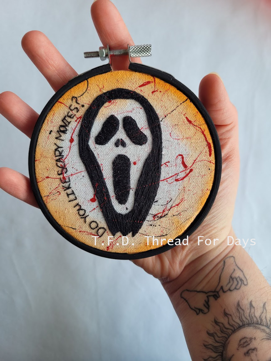Scream mask hoop held in hand
