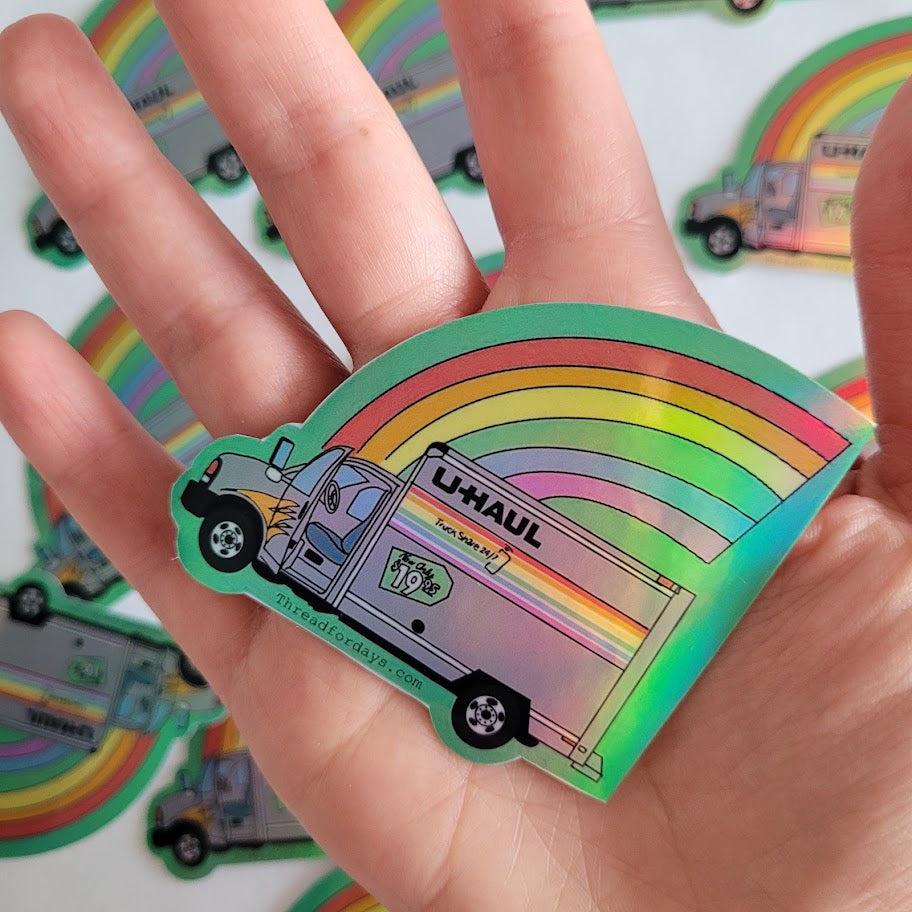 rainbow uhaul sticker held in palm