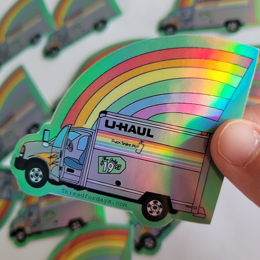 rainbow uhaul sticker held in hand