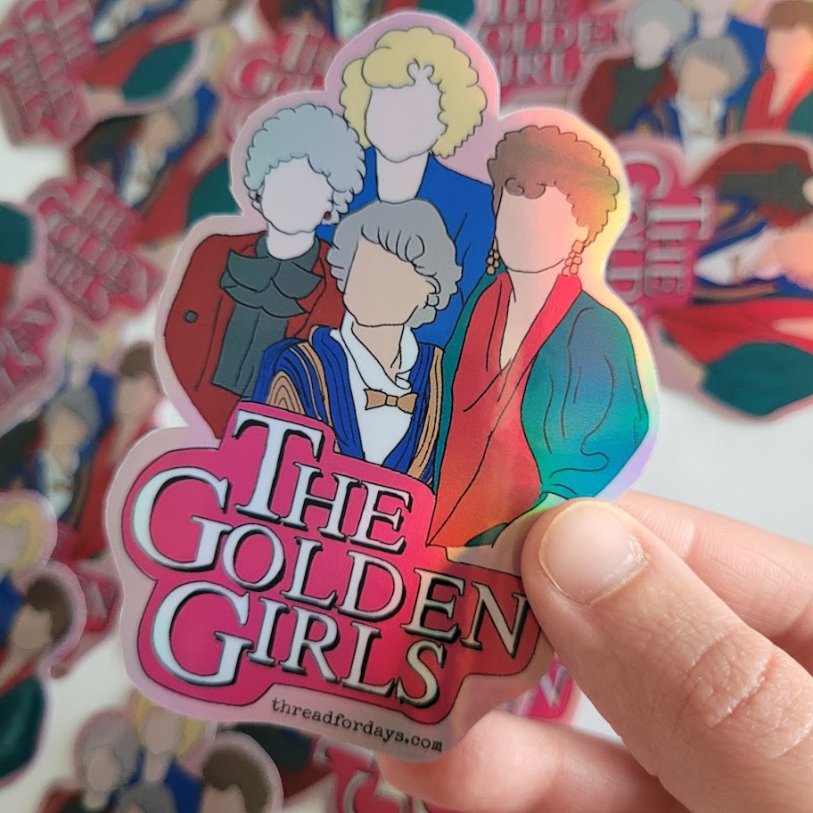 the golden girls sticker held in hand