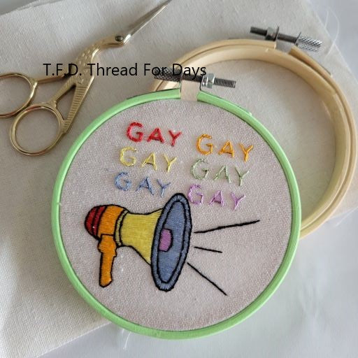 say gay embroideru hoop with fabric an additional hoop and embroidery scirsors