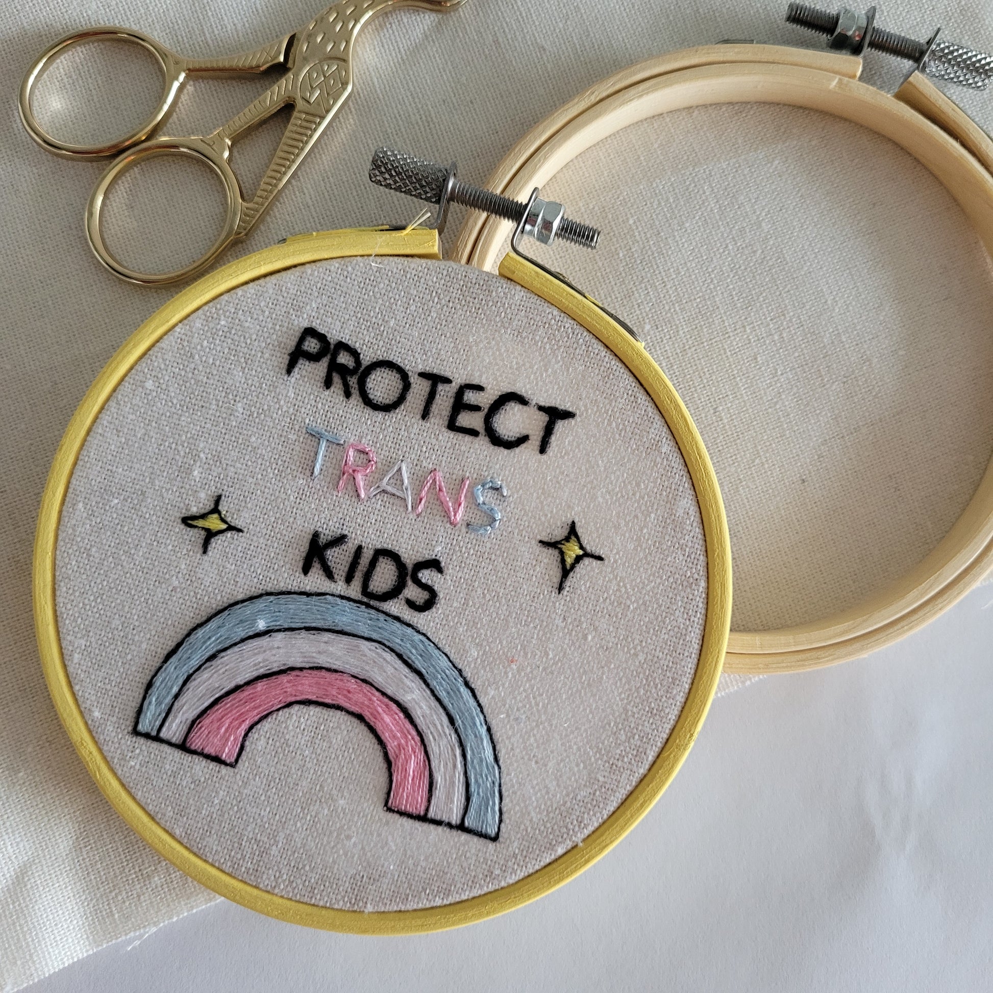 Protext trans kids with a trans coloured rainbow
