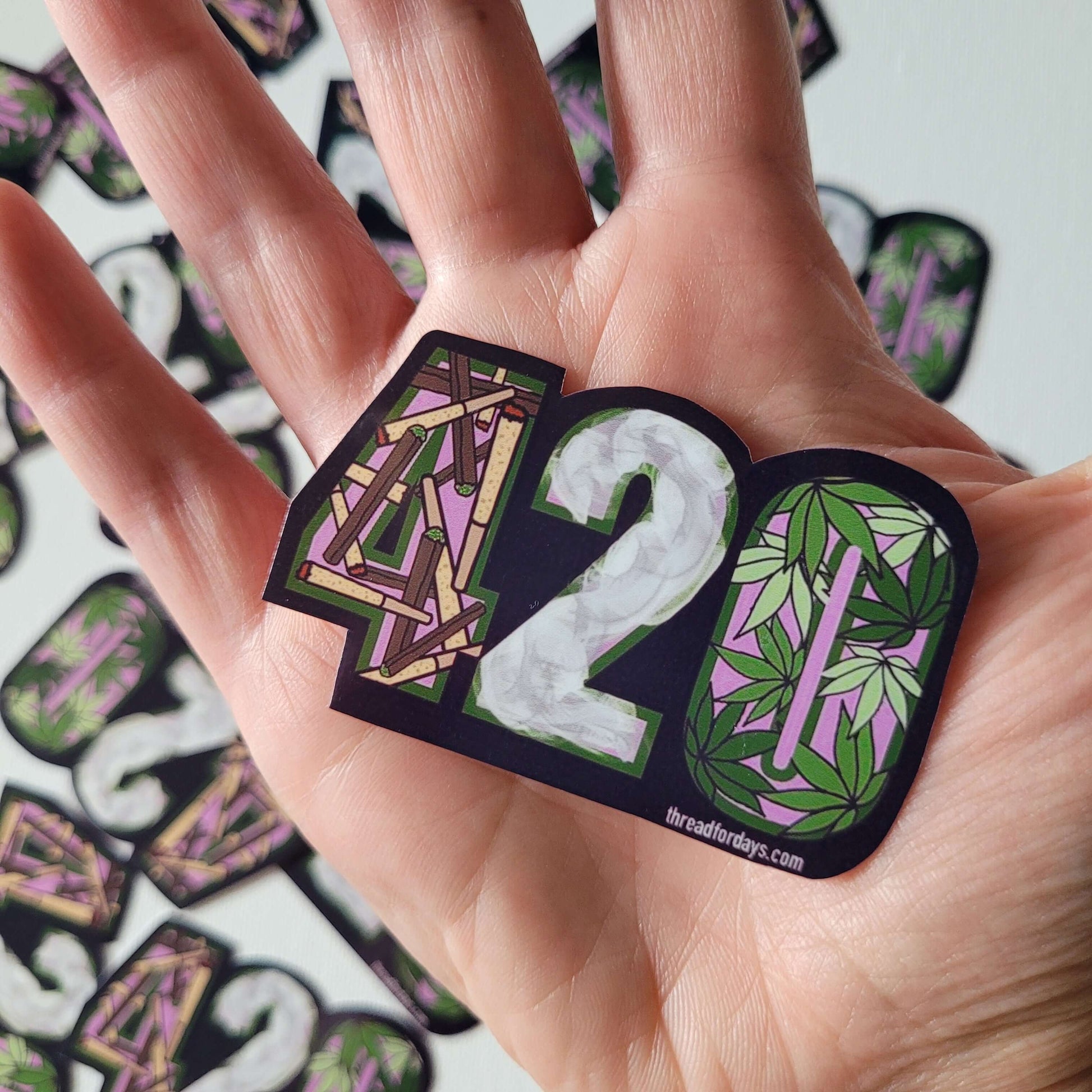420 sticker in palm of hand for sizing