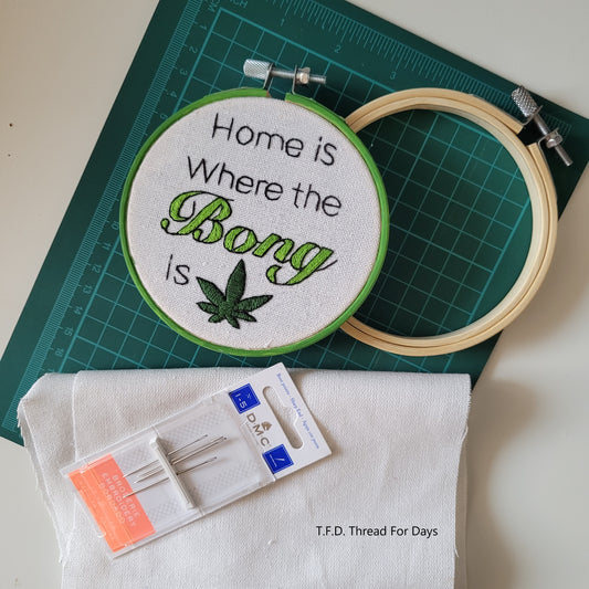 Home is where the bong is hoop with empty embroidery hoop fabric and needle