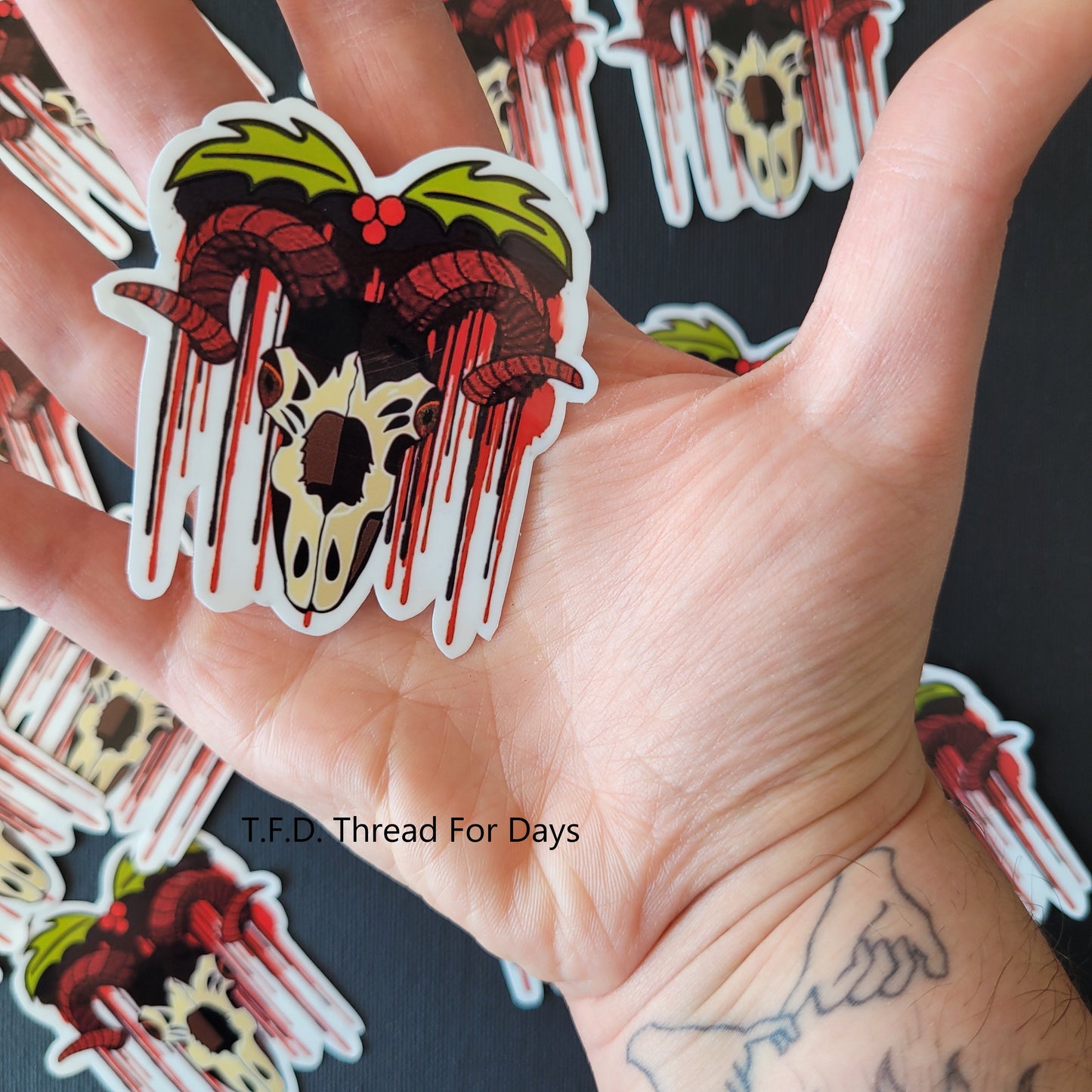 krampus sticker in palm of hand to demonstrate size