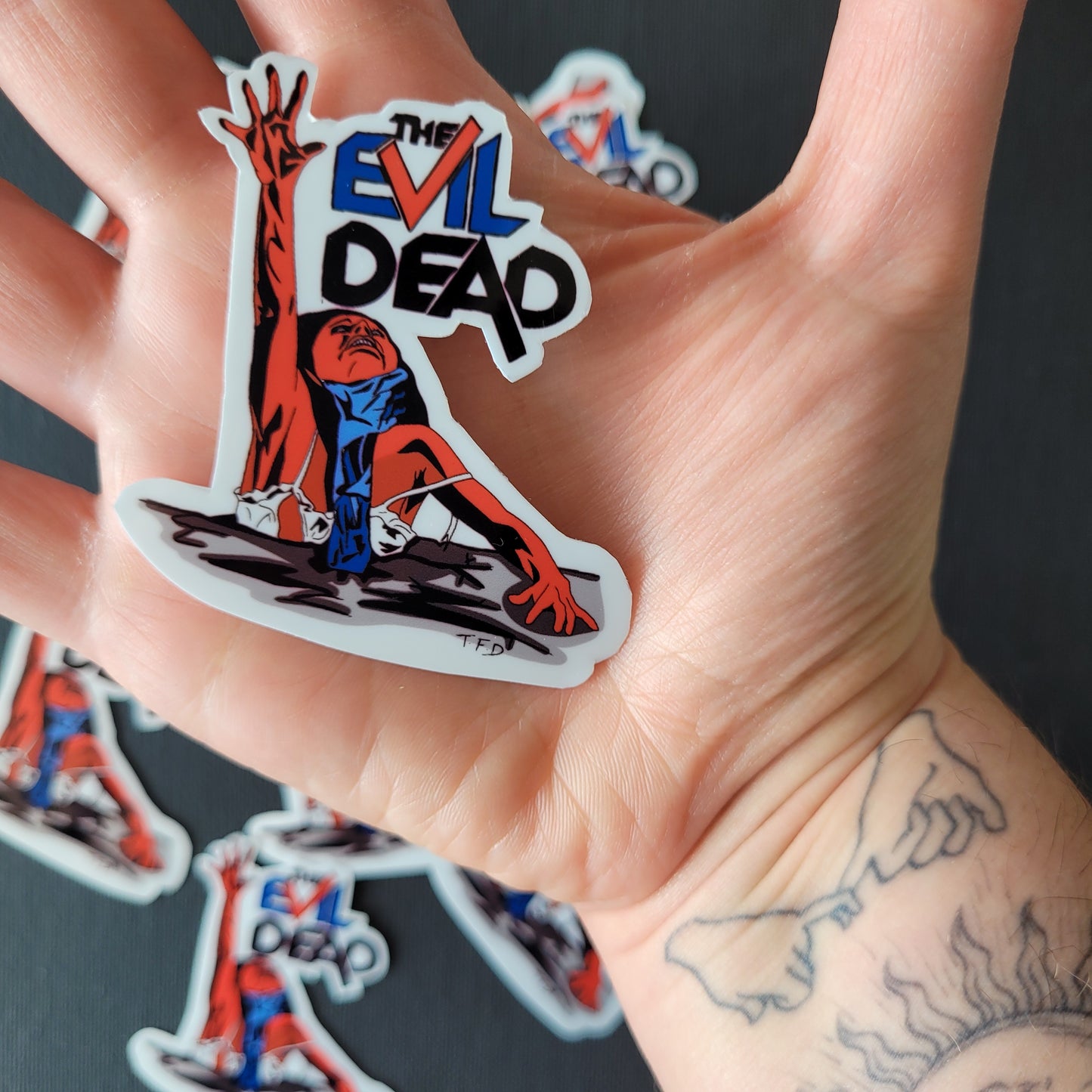 The Evil Dead Sticker held in palm to demonstrate size