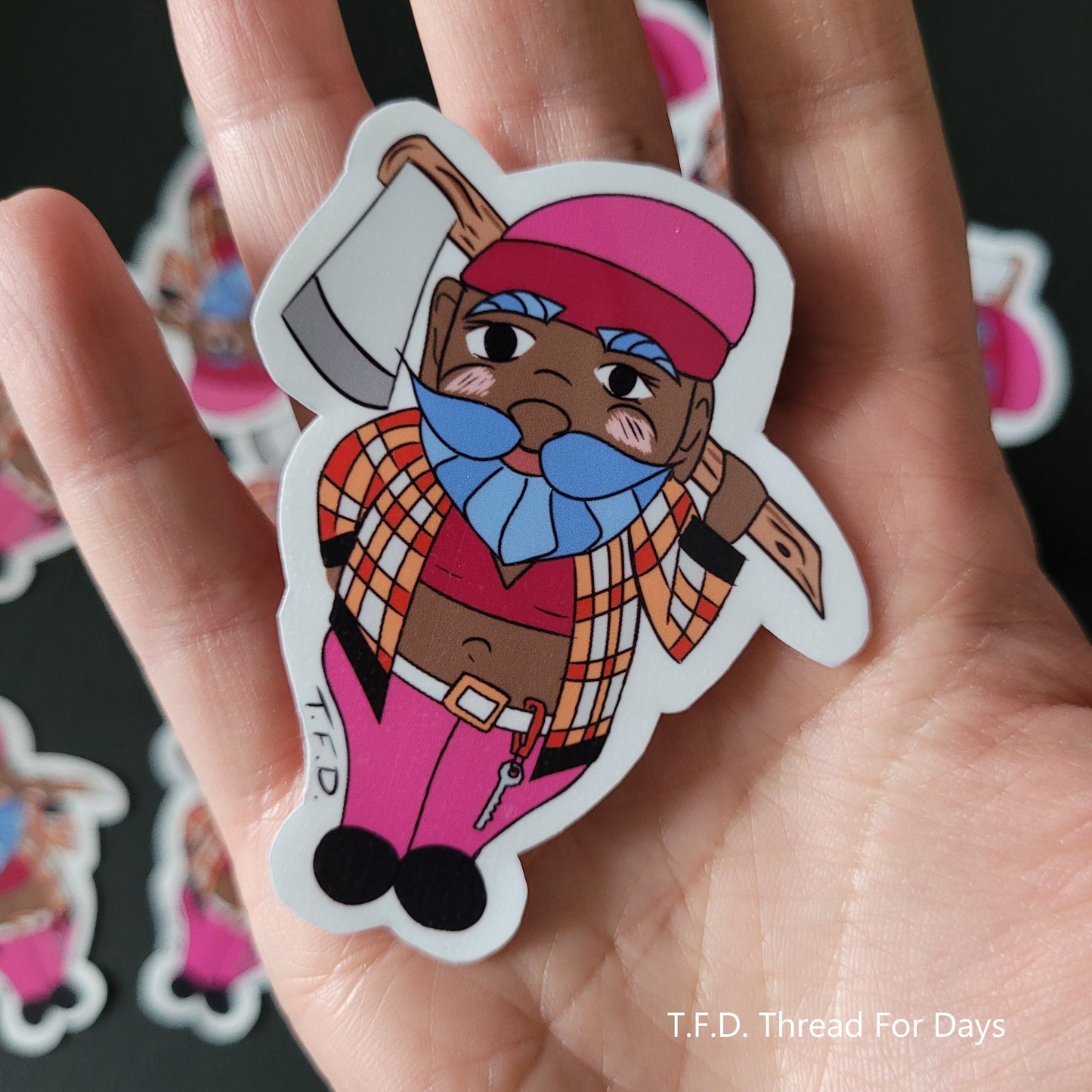 lesbian gnome sticker held in palm of hand for size
