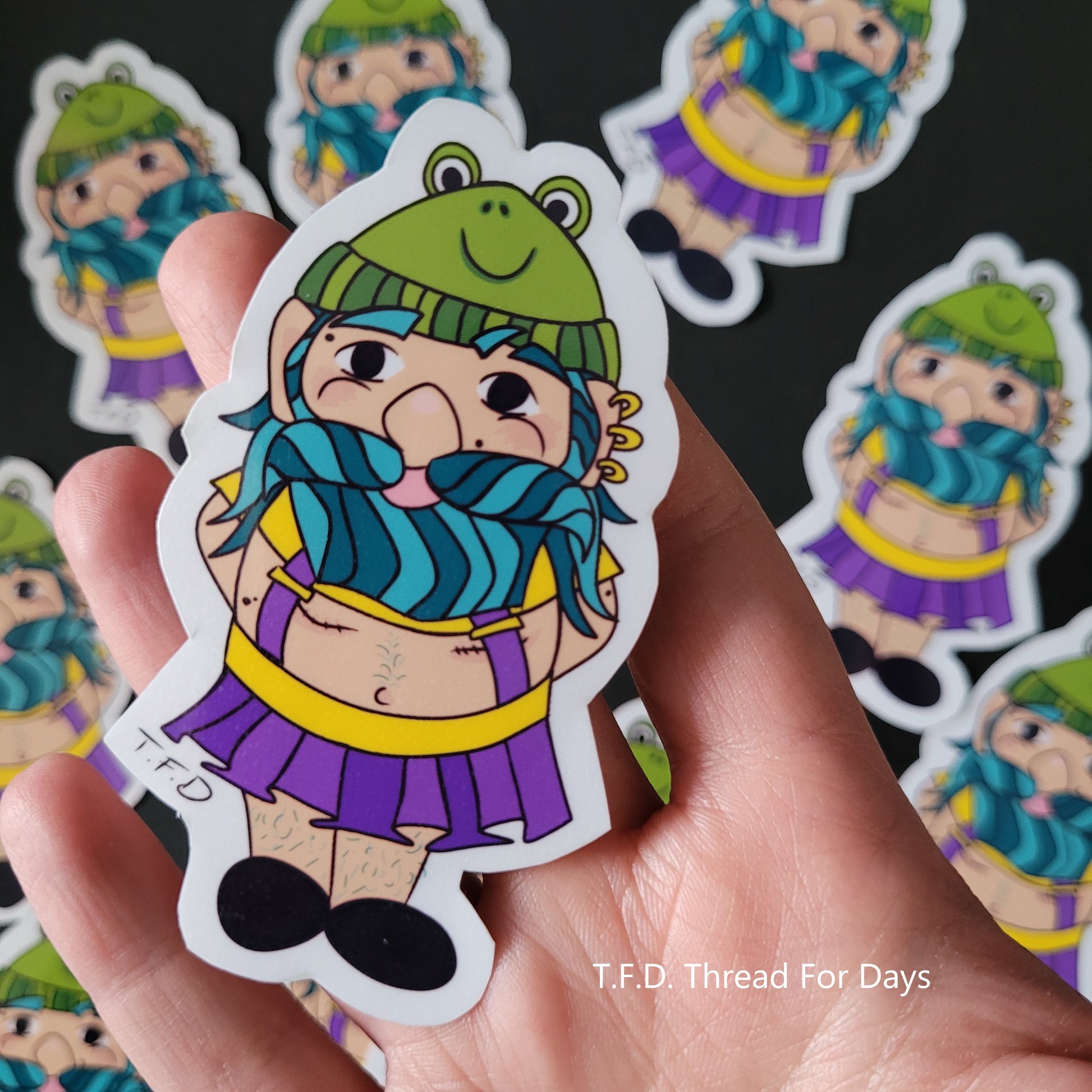 non-binary gnome sticker held in palm of hands