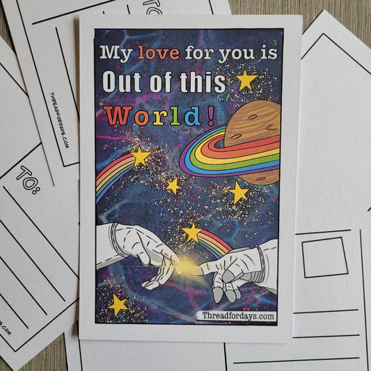 front of space gays postcard with two astronauts fingers reaching out and barely touching one another in space. Rainbow stars and planets are in the galaxy with text that reads " my love for you is out of this world" 