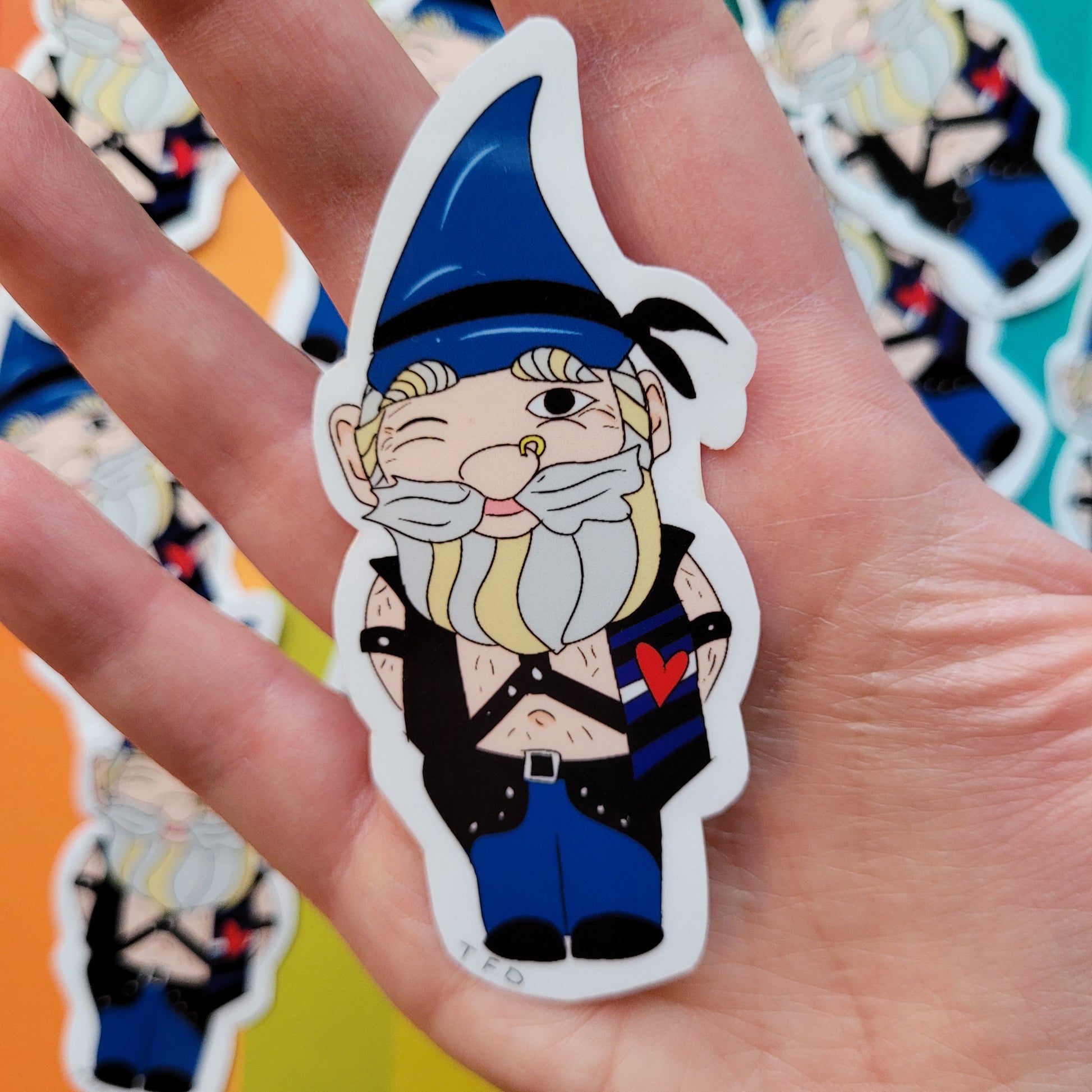 leather daddy gnome sticker held in palm of hand for size