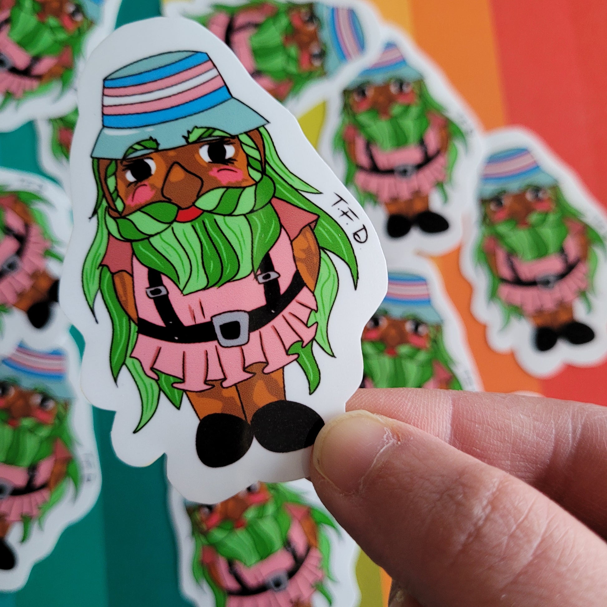 trans gnome sticker between fingers