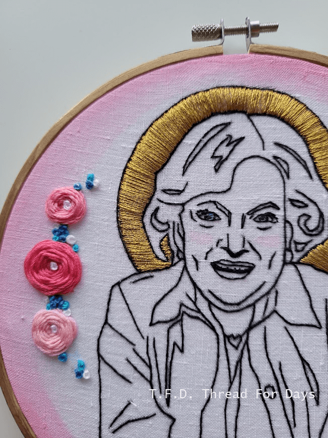 Close up of betty white hoop showing golden halo and roses.