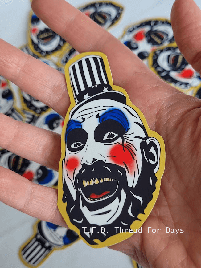 captain spalding sticker in palm of hand