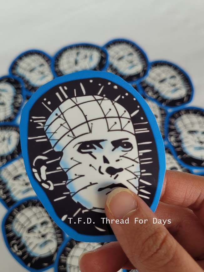 pinhead sticker held with fingers