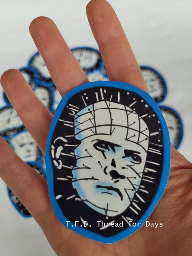 pinhead sticker in palm of hand