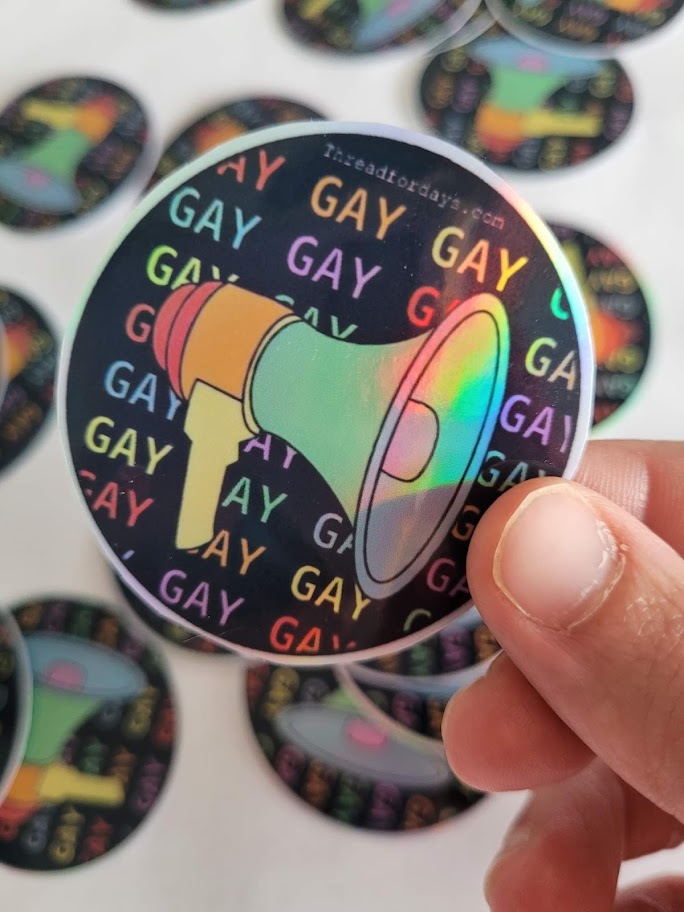 say gay sticker held in hand