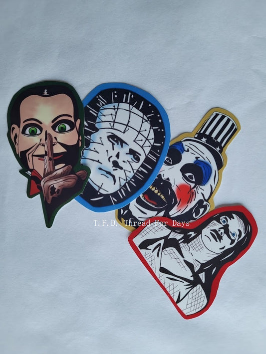 Billy the doll, Pinhead, Captain spalding, and Carrie vinyl sticker on white background